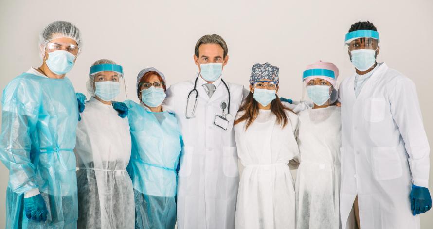 Team of doctors and nurses wearing disposable protection suits and face masks for fighting Covid-19 ( Corona virus ) - Medical team portrait during coronavirus pandemic quarantine, concepts about healthcare and medical